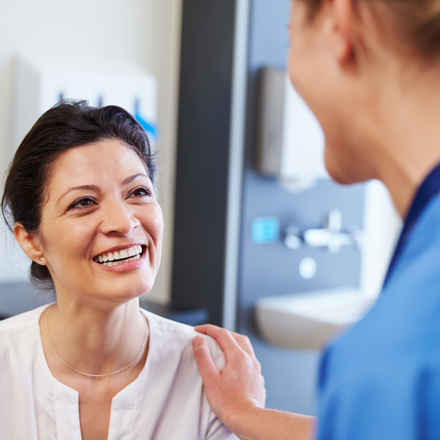 Nurse and patient smiling