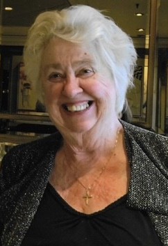 Marilyn, a woman in her 70s with shoulder length grey hair smiling to camera 