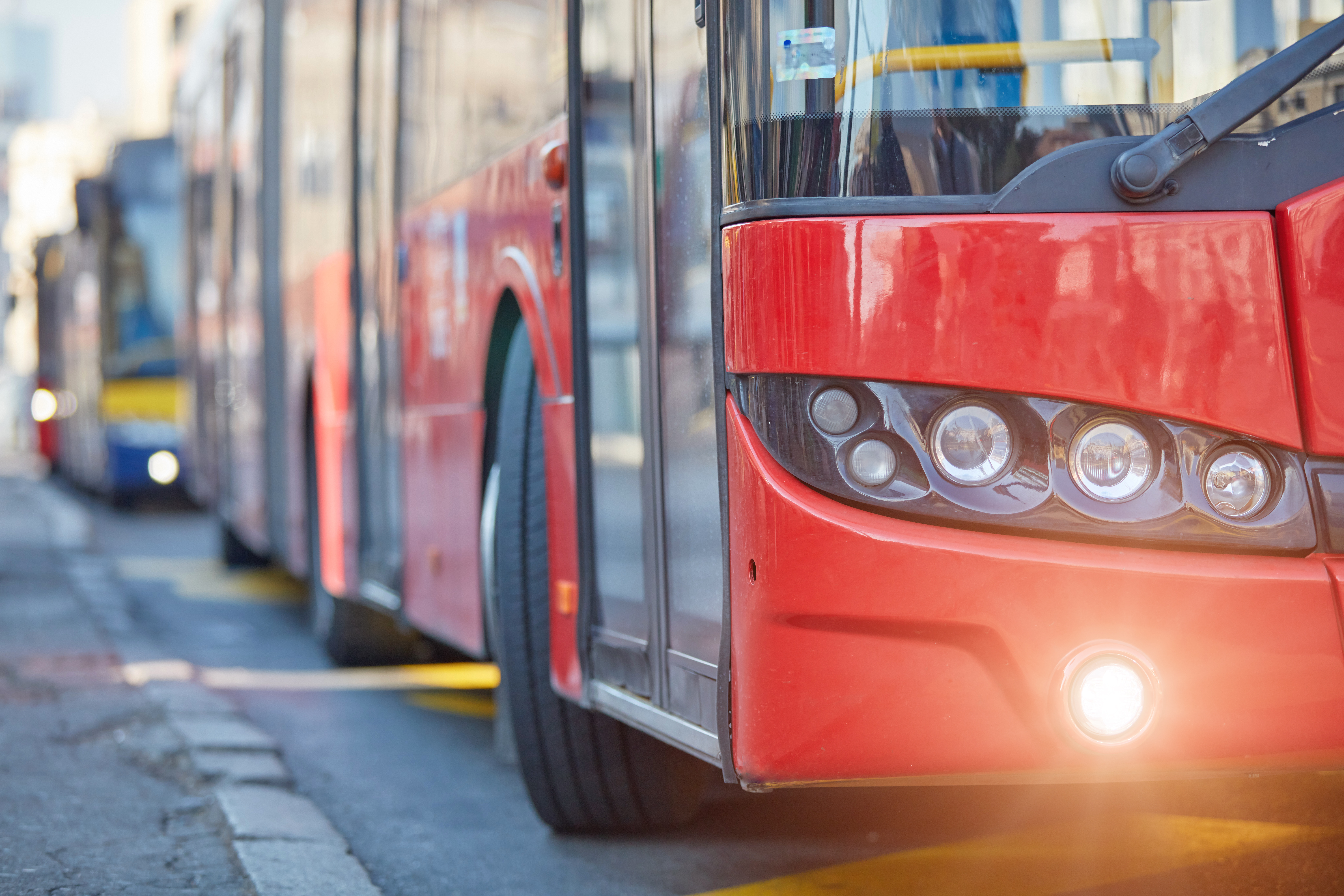 Red bus next to kerb
