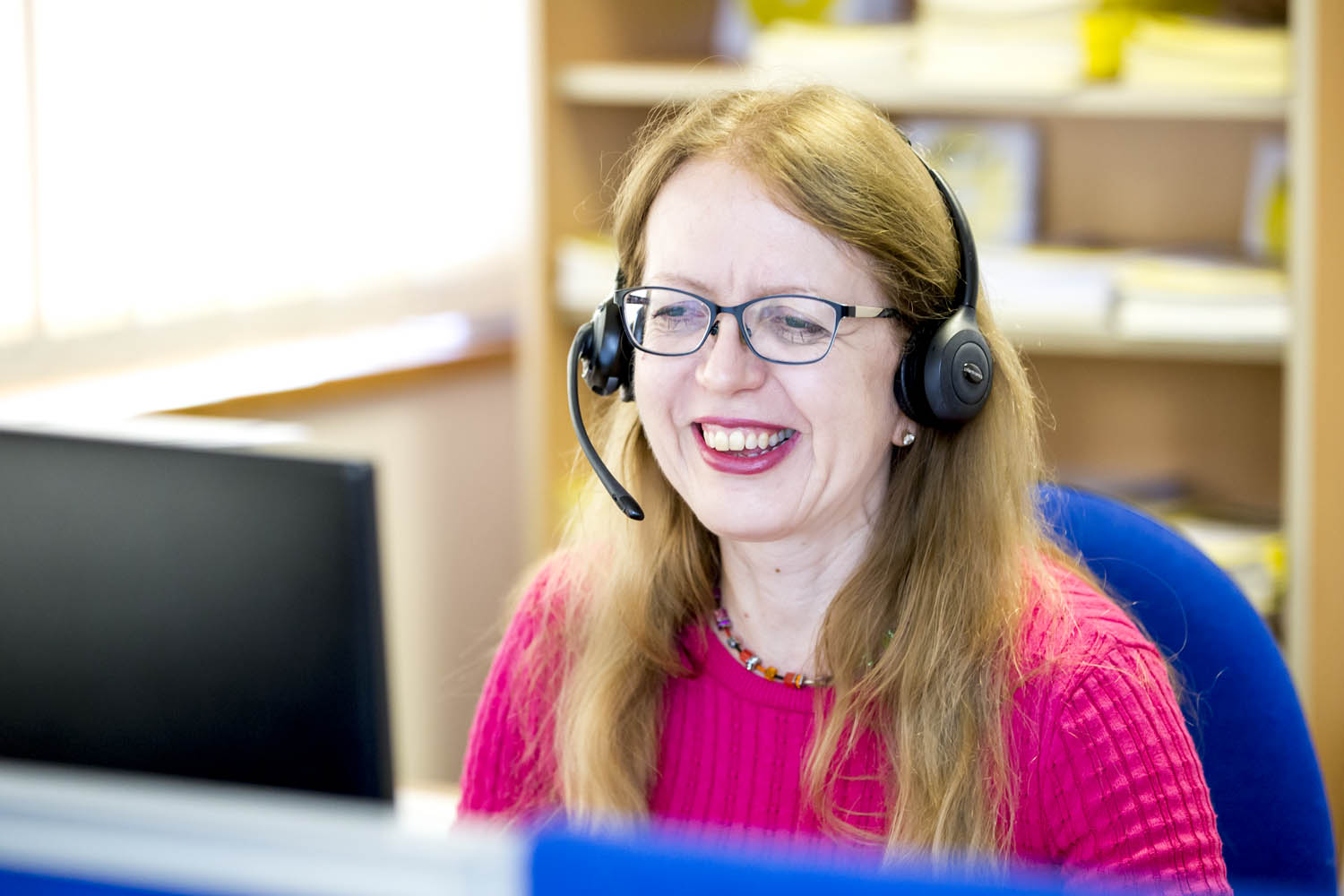 staff member on phone smiling