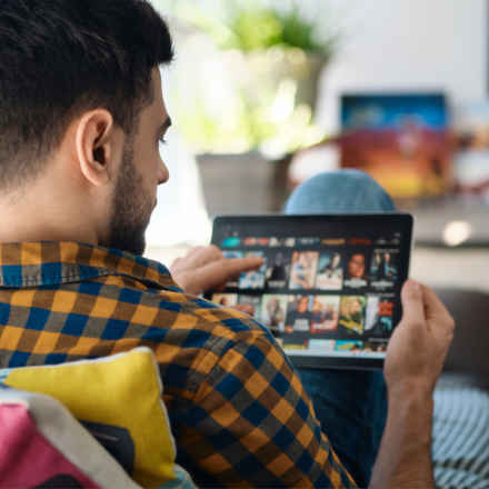 Man sitting on sofa with tablet