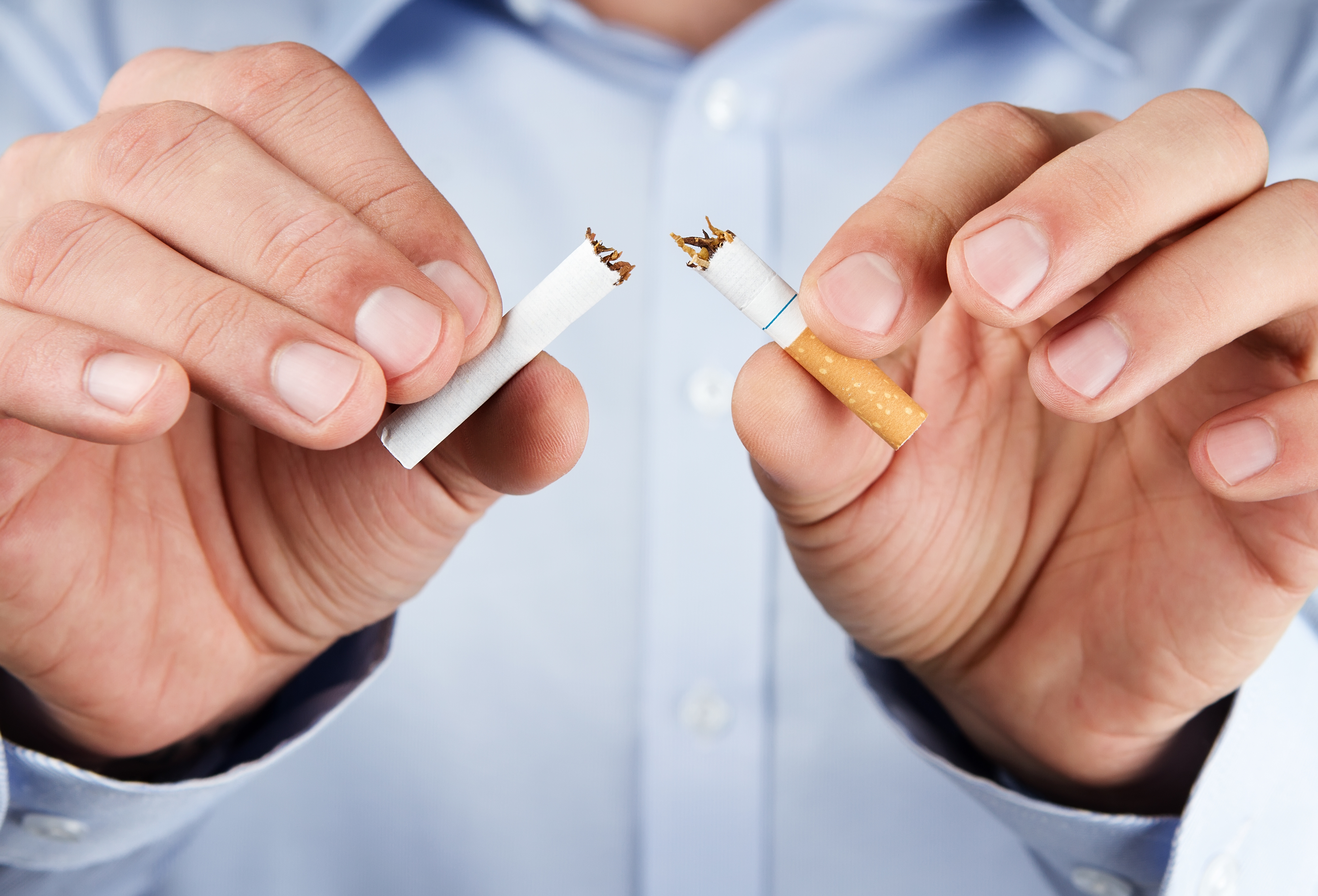 Hands breaking a cigarette