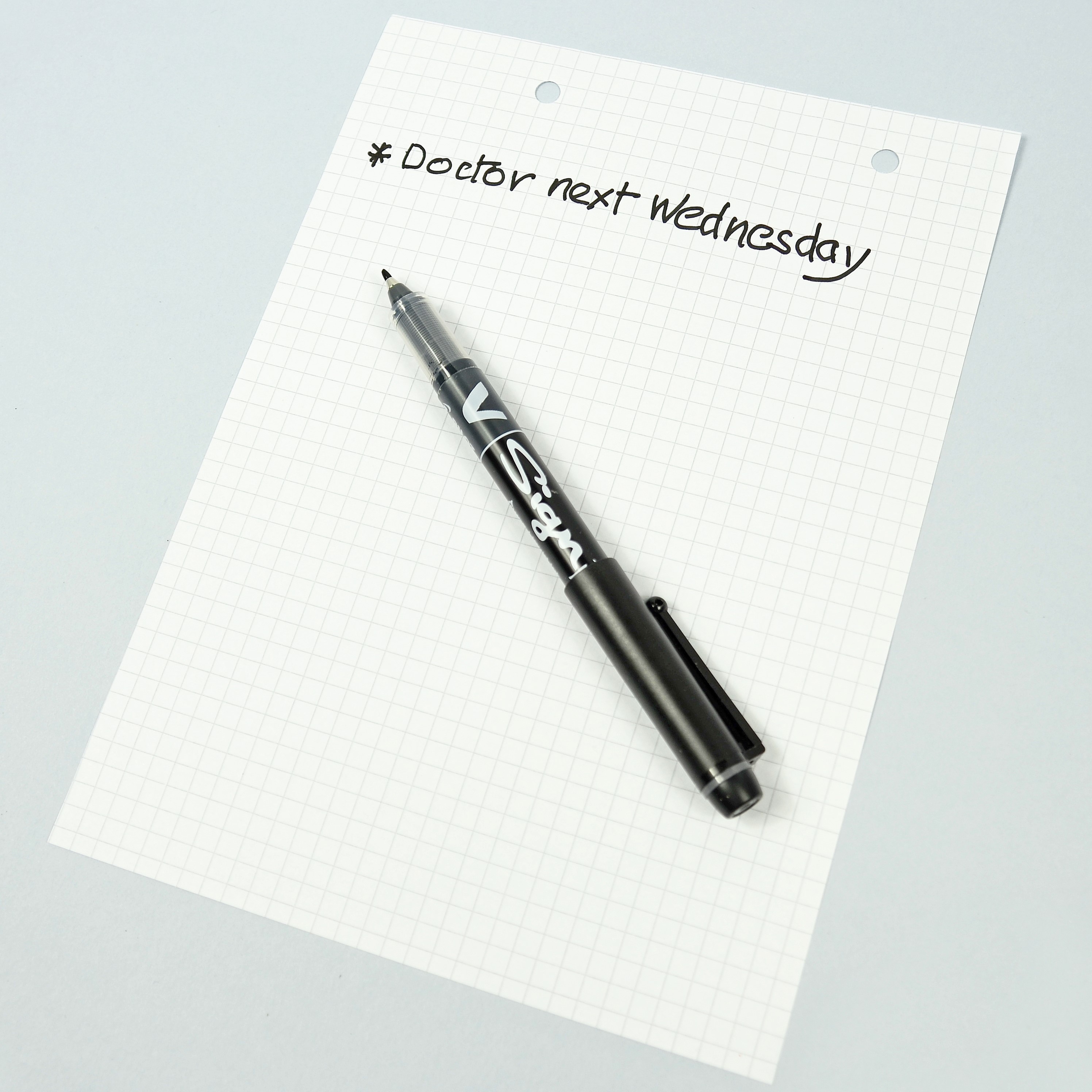 V Sign pen example writing on pad
